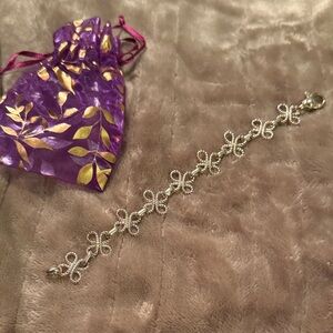 Silver toned twisted rope style knot link bracelet.